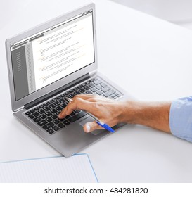 business, technology, programming and people concept - close up of businessman with coding on laptop computer screen working at office