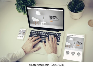 business, technology and responsive design concept: hands writing on a laptop with phone and tablet interior design website screen