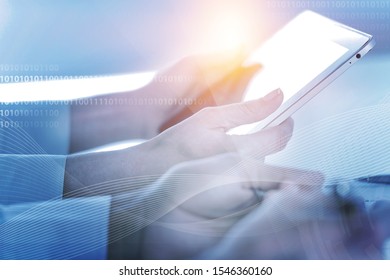 Business and technology, software development, IoT concept. Double exposure of man programmer, software developer working on digital tablet and smart city with binary, html computer code on screen
