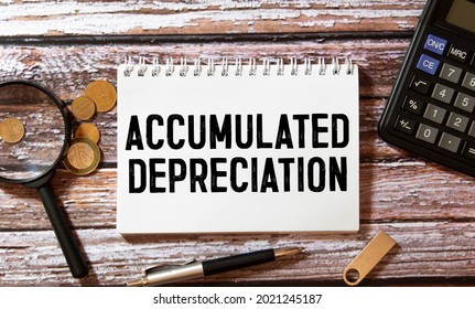 Business Term Phrase On Tablet PC With A Cup Of Coffee And Pens On A White Background - Black Word On A White Background - Accumulated Depreciation