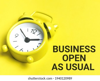 Business and time concept. Phrase BUSINESS OPEN AS USUAL written on yellow background with alarm clock. - Shutterstock ID 1940120989
