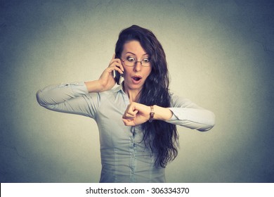 Business And Time Management Concept. Stressed Businesswoman Looking At Wrist Watch, Running Late For Meeting 