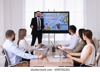 Business Trainer Near Interactive Board In Meeting Room During Presentation