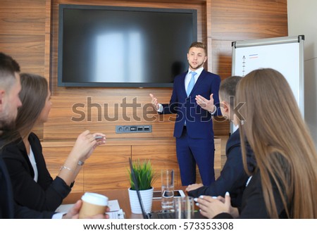Business training at office, businessman presenting successful financial numbers on screen of plasma TV at meeting room