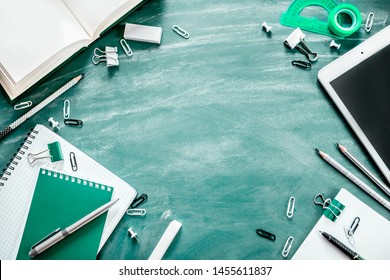Business training or student lectures. Notebook, pen, tablet notebook, pencils on the table, chalk and chalk board. Flat layout, long banner with copy space. School and office supplies. - Shutterstock ID 1455611837
