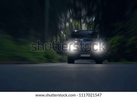 Business transfer vip van ride fast in forest. Luxury minivan car in motion. Car go fast with bright lights 