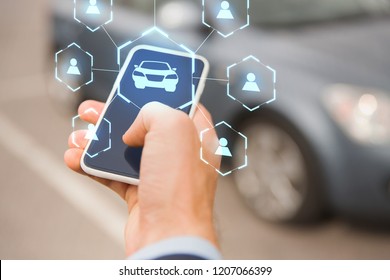 Business, Transportation And Future Technology Concept - Close Up Of Businessman Hand With Smartphone And Virtual Car Sharing Icons