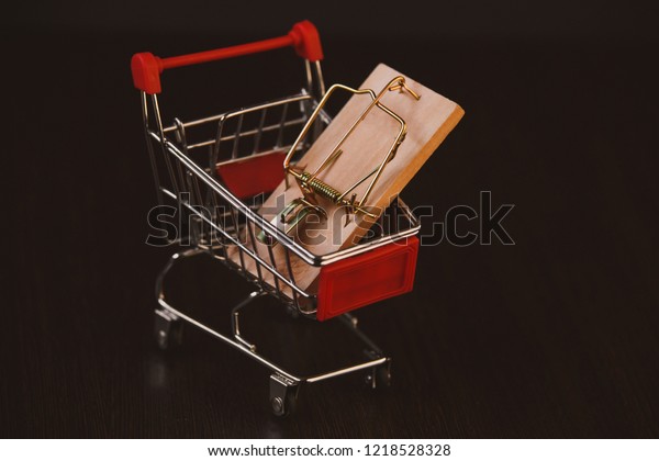 Business trap, Shopping basket with dollar\
bank notes, isolated on white\
background