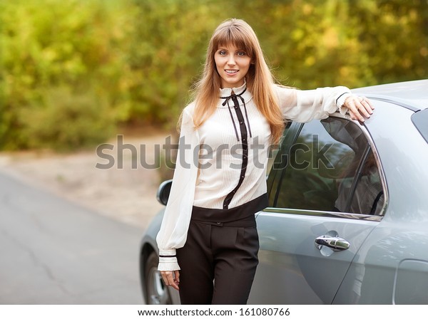 business travel: busy businesswoman with document and\
laptop in car