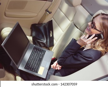 business travel, busy businesswoman with laptop in car