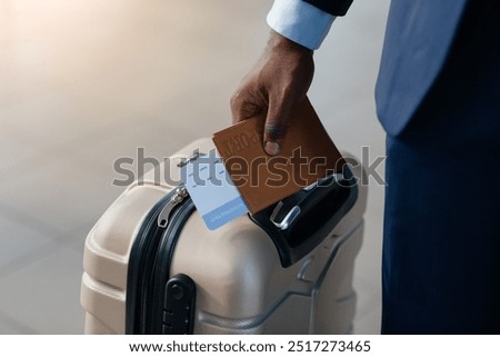 Business Travel Concept. Businessman Holding Passport And Boarding Pass Standing With Suitcase At Airport. Closeup, Selective Focus, Panorama