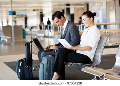 Business Travellers Waiting For Their Flight At Airport