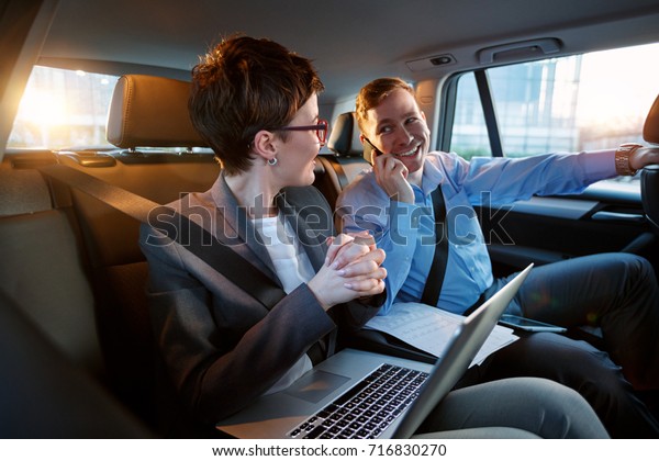 Business trip-\
Talking on mobile to work of\
car\
