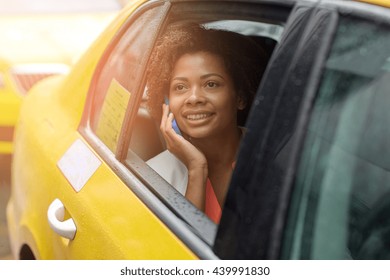 Business Trip, Transportation, Travel, Gesture And People Concept - Young Smiling African American Woman Calling On Smartphone In Taxi At City Street