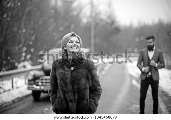 business trip of woman and driver. business trip of\
lady in coat and bearded\
man