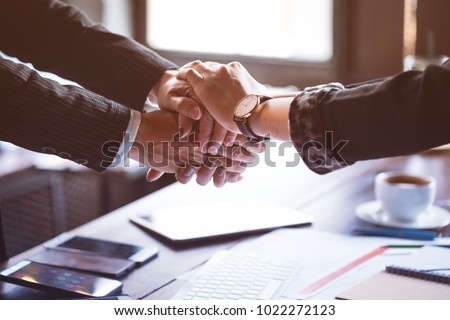  Business trust commitment which Business Partners holding hands with Help, trust ,support ,empathy and factors relationship marketing for reach successful achievement and meeting commit concept.