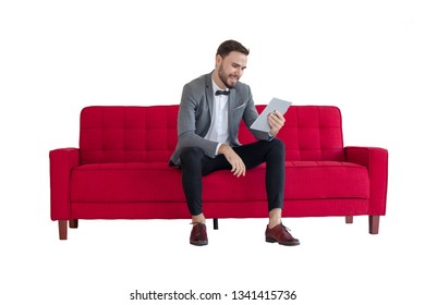 Business  using digital tablet while sitting on sofa