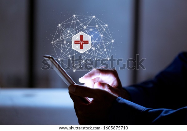 Business using smartphone,with medical\
icon,insurance online and medical online\
concept.