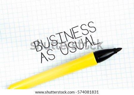 BUSINESS AS USUAL concept write text on notebook