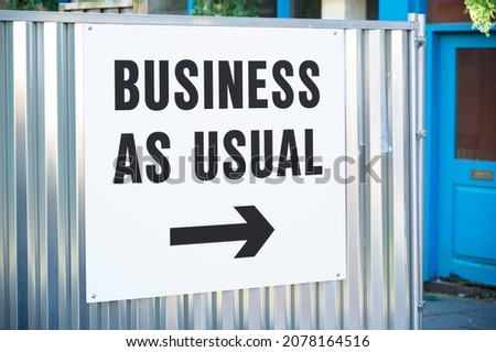Business as usual open sign with direction arrow