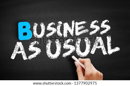 Business as Usual text on blackboard, business concept background
