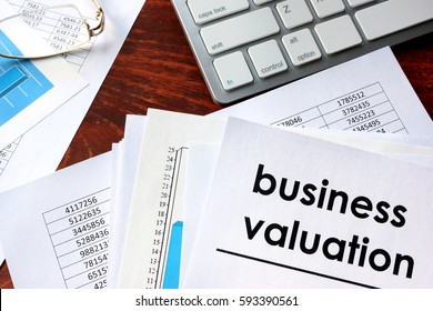 Business Valuation Written In A Document And Business Charts.