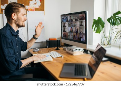 Business video conferencing. Young man having video call via computer in the home office. Multiethnic business team. Virtual house party. Online team meeting video conference calling from home - Shutterstock ID 1725467707