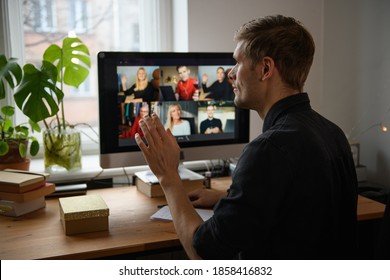 Business Video Conferencing. Young Man Having Video Call Via Computer In The Home Office. Multiethnic Business Team. Virtual House Party. Online Team Meeting Video Conference Calling From Home