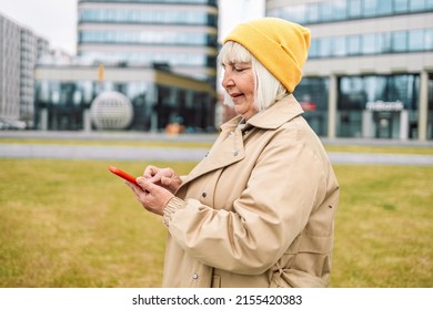 Business Woman 50 Years Old In Stylish Clothes Using Smart Phone With Hand Finger Touch Screen, Texting, Chatting Or Social Media