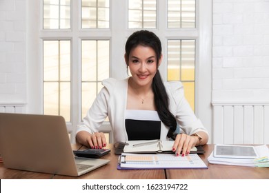 Business Woman Accountant Or Banker Using Calculator In Retro Office. Savings, Finances And Economy Concept.