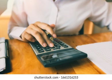 Business Woman Accountant Or Banker Using Calculator In Office. Savings, Finances And Economy Concept.