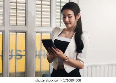 Business Woman Accountant Or Banker Using Calculator In Retro Office. Savings, Finances And Economy Concept.