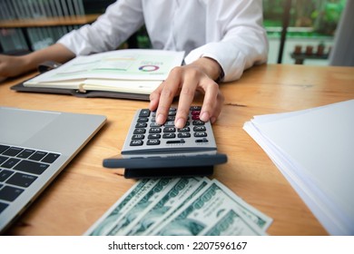 Business Woman Accountant Or Banker Using Calculator In Office. Savings, Finances And Economy Concept.