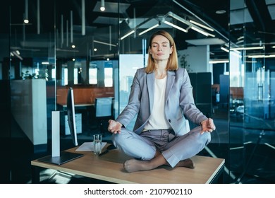 Business Woman Alone Sitting At Desk In Her Office, Female Employee Meditating In Lotus Position