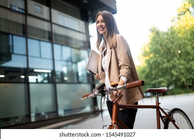 Business woman with bicycle to work on urban street in city. Transport and healthy lifestyle concept