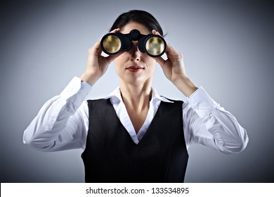 Business Woman With Binoculars Spying On Competitors.