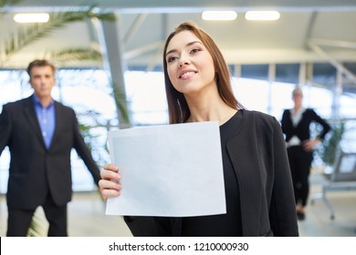 Business Woman With A Blank Welcome Sign At The Airport Terminal For A Guest