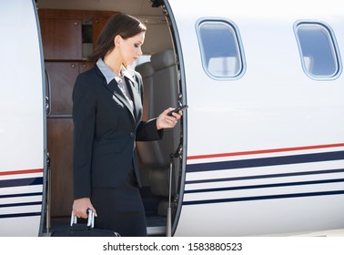 A Business Woman Boarding A Plane