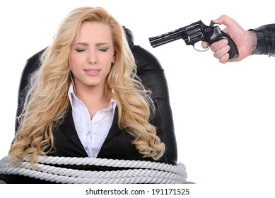 Business woman bound to a chair with rope and aim it to the head with a gun isolated on a white background