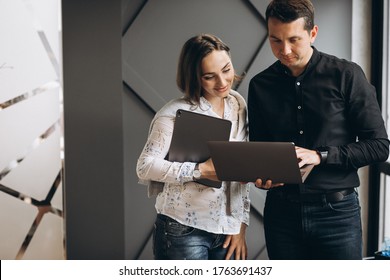 Business Woman And Bussiness Man Colleagues Working On Laptop