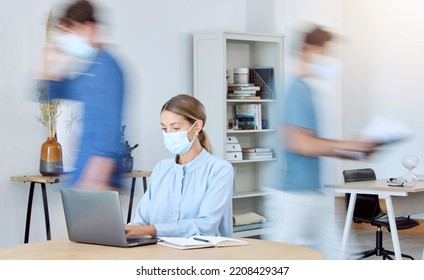 Business Woman, Busy Office And Covid Compliance While On Laptop And Blur Of People Around Her. Employees In The Office During Coronavirus Wearing Face Mask And Working In Company After Lockdown