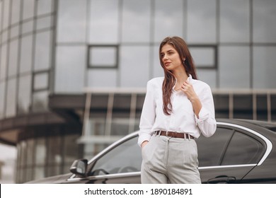 Business woman by the car