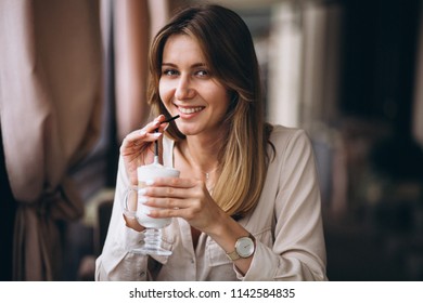 Business woman in a cafe drinking latte