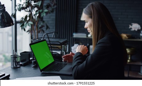 Business Woman Calling Video On Laptop Computer With Green Screen In Office. Female Entrepreneur Having Video Conference Online At Remote Workplace. Businesswoman Gesturing During Video Conversation