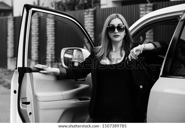 Business woman in a car, auto lady concept.
Stylish lady in black jacket and
glasses