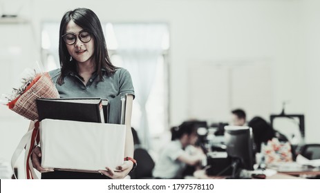 Business Woman Carrying Packing Up All His Personal Belongings And Files Into A White Cardboard Box To Resignation In Modern Office, Resign Concept