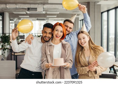 Business woman celebrating birthday and doing a party with colleagues in her office. - Powered by Shutterstock