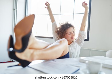 Business Woman Celebrating Her Success With Her Feet Up