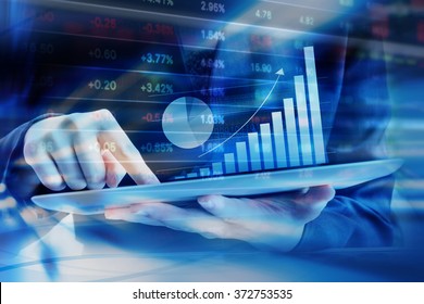 Business woman are checking stock market graph on digital tablet - Shutterstock ID 372753535