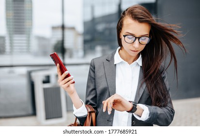 A business woman checks the time in the city during a working day waiting for a meeting. Discipline and timing. An employee goes towards a corporate meeting. - Shutterstock ID 1777685921
